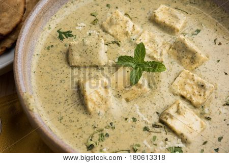 methi malai paneer or Creamy Fenugreek & Paneer Curry, popular north indian recipe prepared using milk cream, methi and paneer or cottage cheese, served with roti/paratha, selective focus