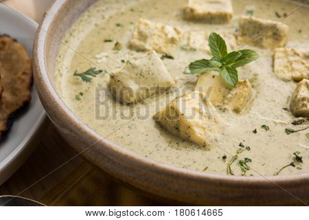 methi malai paneer or Creamy Fenugreek & Paneer Curry, popular north indian recipe prepared using milk cream, methi and paneer or cottage cheese, served with roti/paratha, selective focus