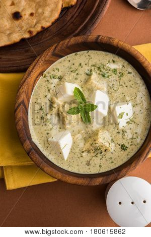methi malai paneer or Creamy Fenugreek & Paneer Curry, popular north indian recipe prepared using milk cream, methi and paneer or cottage cheese, served with roti/paratha, selective focus