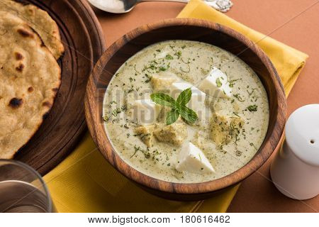 methi malai paneer or Creamy Fenugreek & Paneer Curry, popular north indian recipe prepared using milk cream, methi and paneer or cottage cheese, served with roti/paratha, selective focus