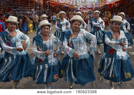 ORURO, BOLIVIA - FEBRUARY 26, 2017: Morenada dance group in colourful outfits parading through the mining city of Oruro on the Altiplano of Bolivia during the annual Oruro Carnival.