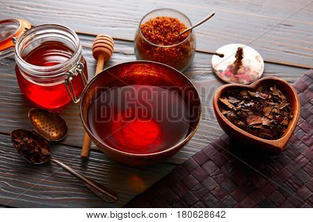 Bancha tea served in golden bowl on wooden table board