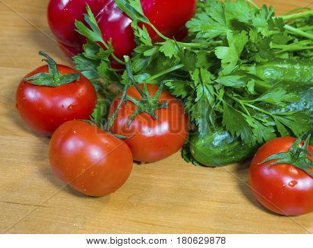 A lot of the fresh vegetables on the wooden table
