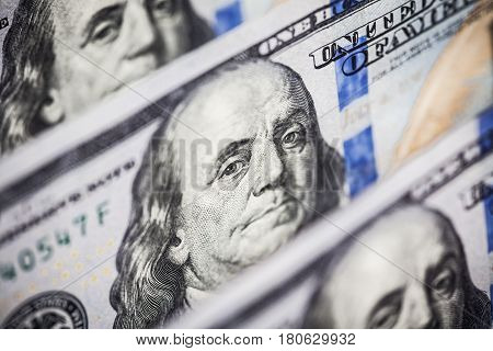 Hundred dollars bills standing in a row. Selective focus