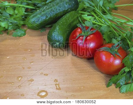 The fresh vegetables on the wooden wet table