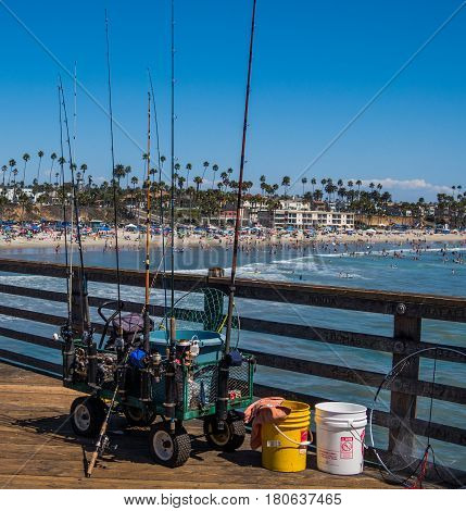 Fishing gear on the pier with beach and coastline in the distance