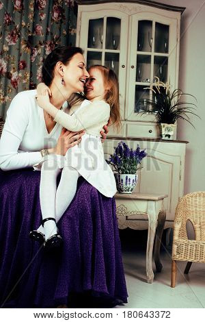 young mother with daughter at luxury home interior vintage, old fashion relashionship family