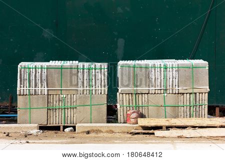 pallets of concrete blocks for the pavement