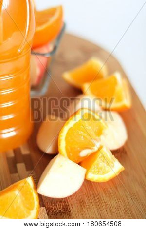 Bottle Of Orange Juice And Sliced Apple And Orange