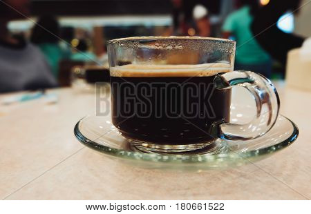 Black Coffee in Crystal Glass on Table Cafeteria Background