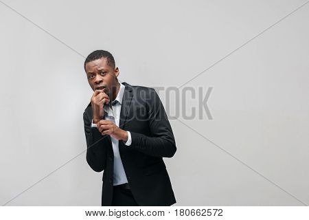 Problems on work. Fear of dismissal, quit. Pressing staff, inability to express will, stress. Afroamerican man on grey with free space.