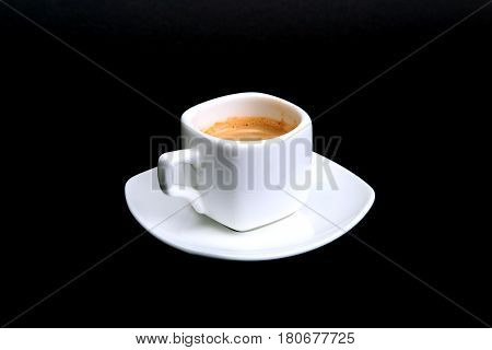 Classic espresso coffee in white cup isolated on dark background. Top View