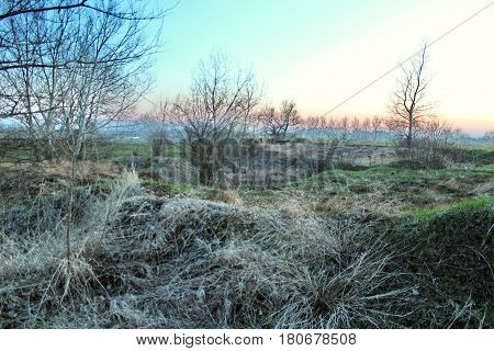 The landscape is mountain steppe with mountains cloudy dramatic blue sky in the beautiful sunset
