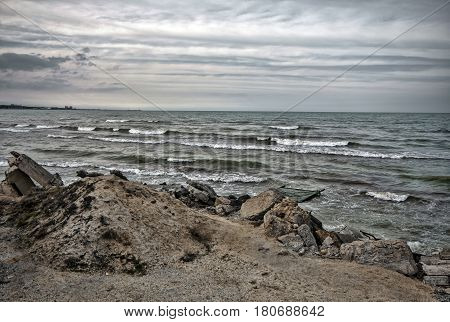 Sunset At The Sea Shore Of A Beach With Rocks And Stormy Waves, Beautiful Seascape At Caspian Sea Ab