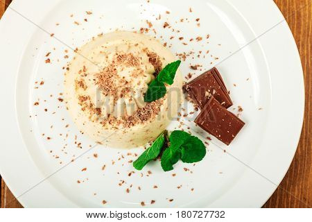 Blancmange with chocolate on glass plate