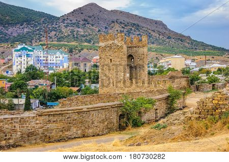 Walls of Genoese fortress in Sudak Crimea. Scenic views of rocky cliffs near ancient Genoese fortress and modern city in the background
