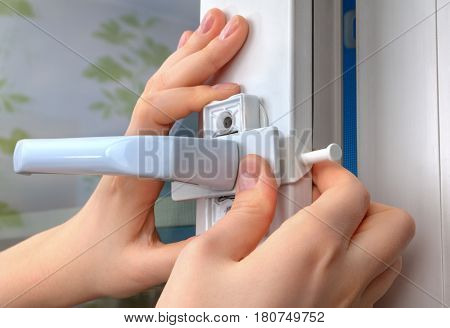 Installation of the window limiter for a plastic window close-up.