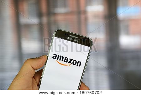 MONTREAL CANADA - MARCH 20 2017 - Amazon mobile application on screen of Samsung S5 in hand. Amazon is an American electronic commerce and cloud computing company.