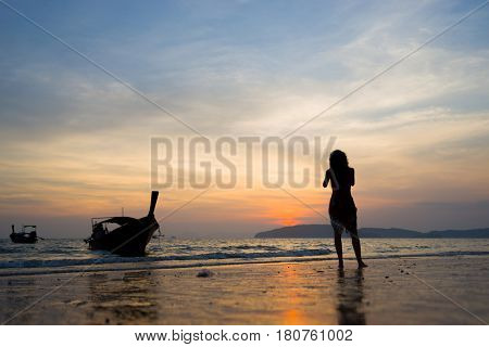 Woman on the beach in Ao Nang Krabi at sunset