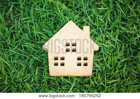 Wooden house on green grass / Eco house