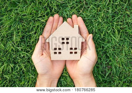 Wooden house on green grass / Eco house