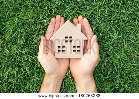 Wooden house on green grass / Eco house