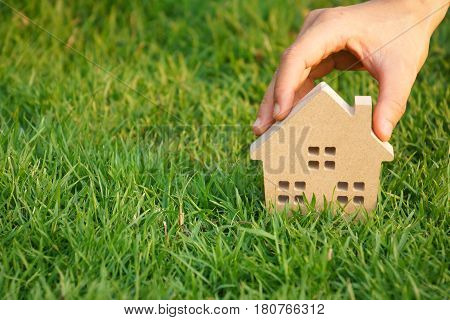Wooden house on green grass / Eco house