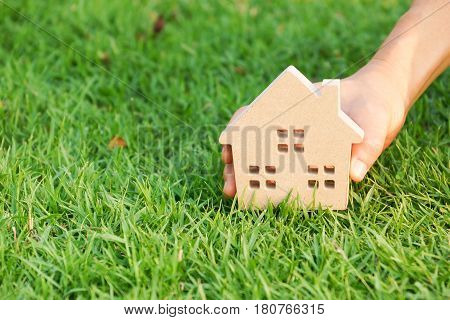 Wooden house on green grass / Eco house