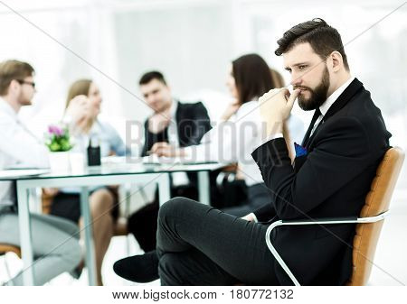 financial Manager of the company on the background of the working meeting the business team.the photo has a empty space for your text