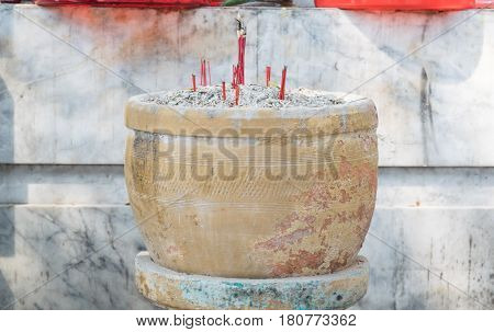 Burning sticks joss in pot at temple