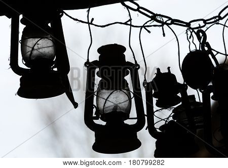 background of many lit storm lanterns or hurricane lamps