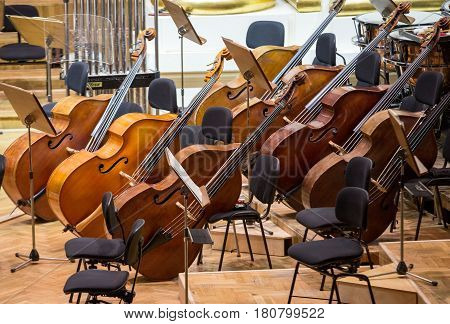 Vintage music instruments old bass viols on stage