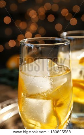 Glass with delicious wine spritzer on dark background