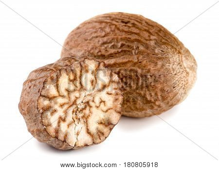 Two nutmeg isolated on white background macro.