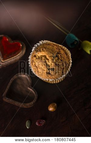 gluten free muffin over a wooden table in a dark set