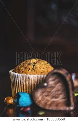 gluten free muffin over a wooden table in a dark set