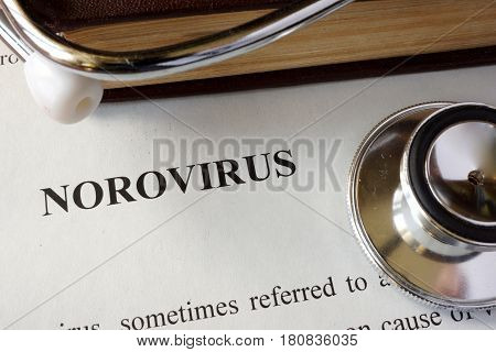 Page with diagnosis Norovirus on a table.
