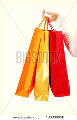Isolated womans hand carries a shopping bag.