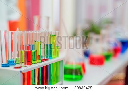 Laboratory expreriment with test-tubes with colored chemical reagents, retorts and flasks