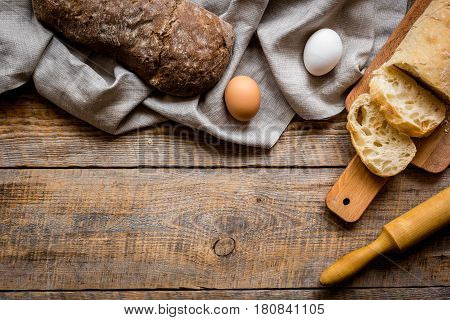 Baking fresh homemade bread on wooden kitchen table background top view moke up