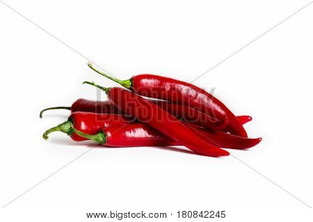 A pods of red hot pepper on a white background