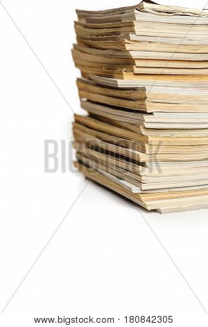 A stack of old magazines on a white background