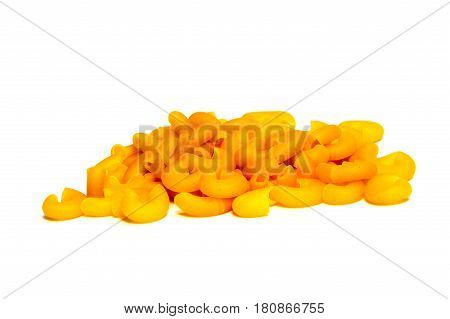 A lot of pasta. Dry pasta. Scattered pasta. Pasta background. Pasta in form of shells. Macaroni products. Macaroni background. Food background.