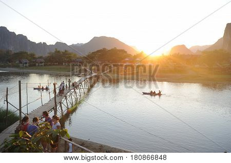 Vang Vien Laos - 15 January 2012: People traveling in a canoe in the river near the village of Vang Vien