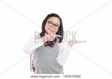 Asian studentwith glasses pointing to open hand palm on white background isolated