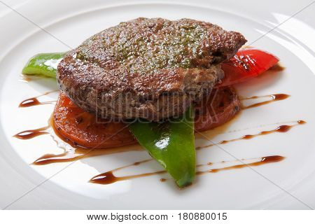 Grilled Steaks And Vegetables On A White Plate