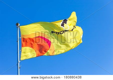 SAMARA RUSSIA - FEBRUARY 20 2016: The flag of oil company Rosneft against blue sky. Rosneft is one of the largest russian oil companies