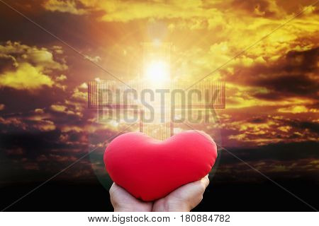 Hand Raise Red Heart Shape On Light From Golden Sky Or Heaven Shine Trough Crucifix Form