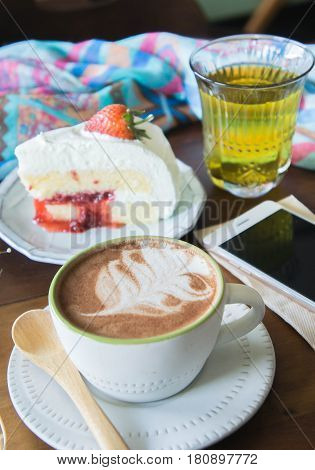 coffee cup and delicious cake strawberry and relax time moblie on table in coffee shop