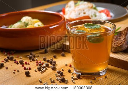 Traditional Ukrainian drink uzvar compote lemonade on a wooden table decorated with lemon
